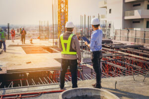 construction workers discussing who to register as a cis subcontractor in the uk
