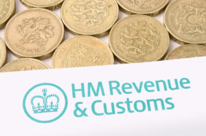 a hmrc nudge letter atop of some 1 pound coins