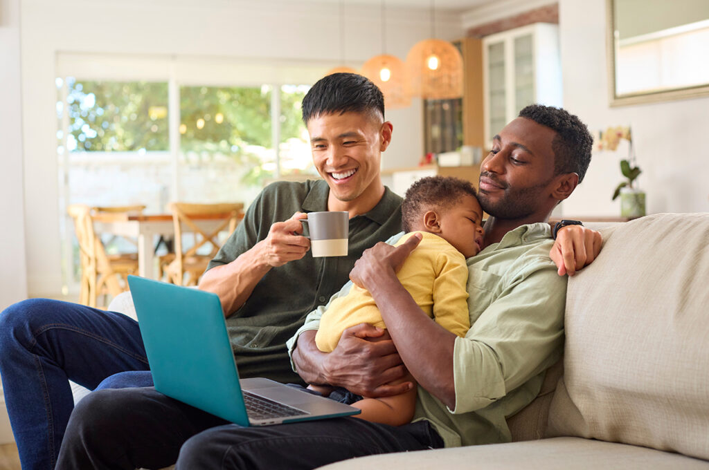 a married couple looking up the specifics of inheritance tax on a laptop while their baby sleeps