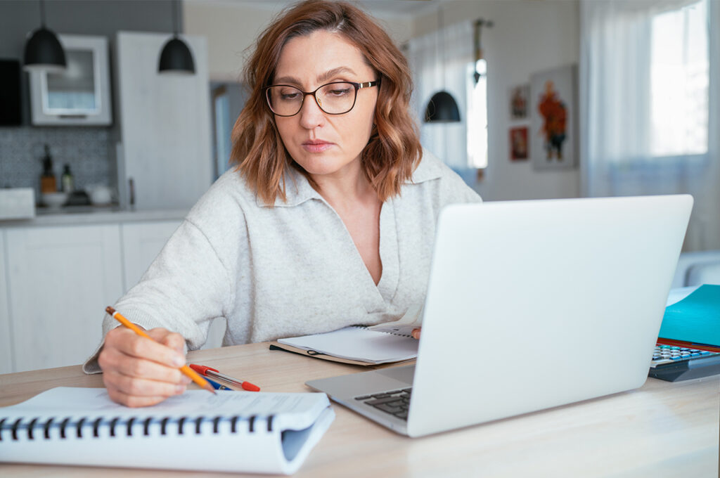 a sole trader working at home in the kitchen calculating capital allowance benefits