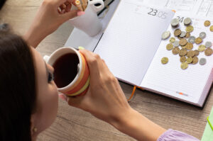 a lady budgeting her savings following the capital gains tax changes during a cosy financial planning session