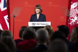 Rachel Reeves speaking at a podium on behalf of the treasury