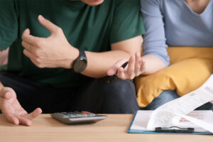 a couple discussing fines for late VAT payment at a desk